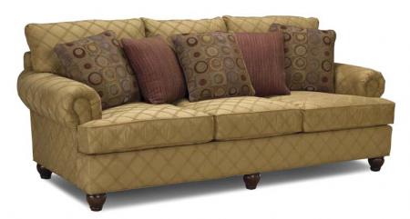 Tan patterned sofa with rolled arms and decorative cushions.