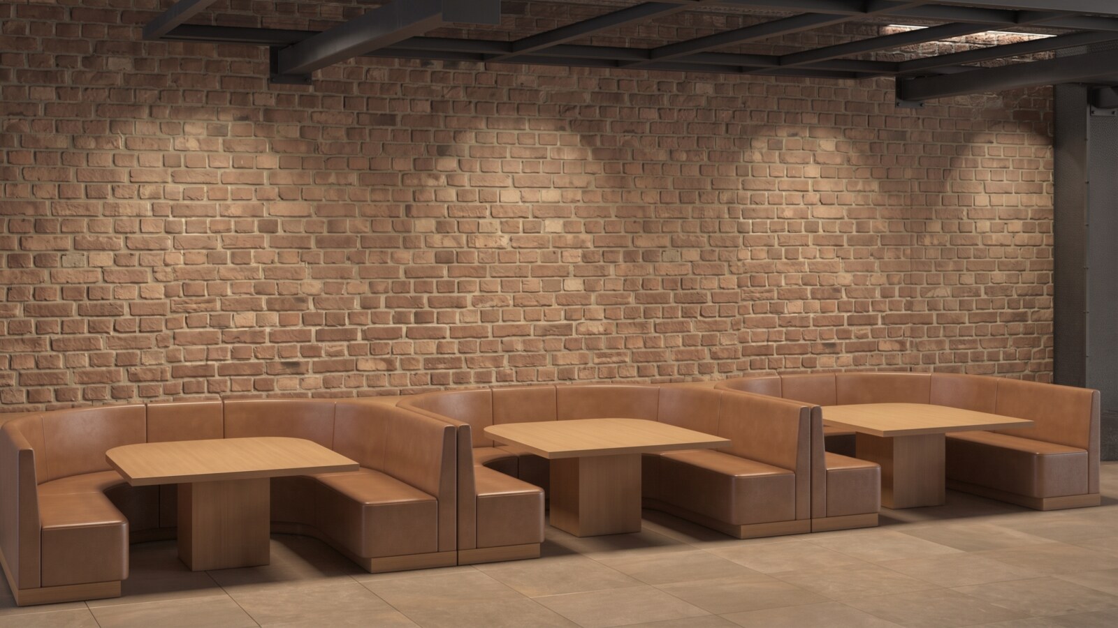 A detailed view of a row of three modern restaurant booths in an industrialstyle interior. The ushaped booths are upholstered in tan leather and paired with matching light wood dining tables. The background features a textured exposed brick wall highlighted by black industrial overhead track lighting and specific spotlights that create pools of light. The floor has light brown square tiles.